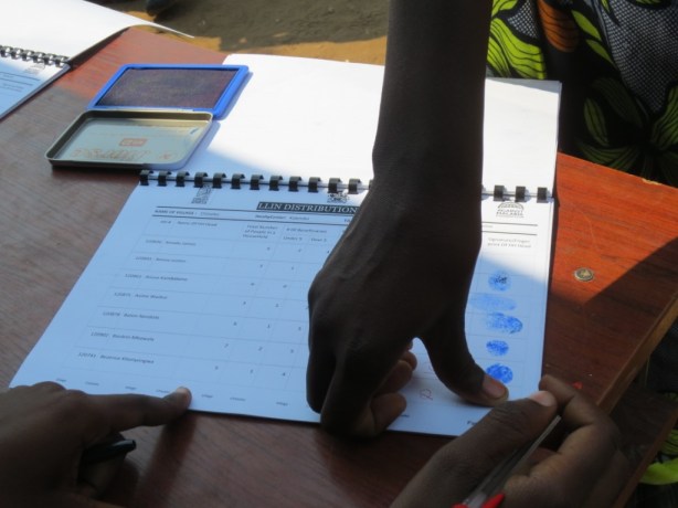 Villagers provide signatures using finger prints 